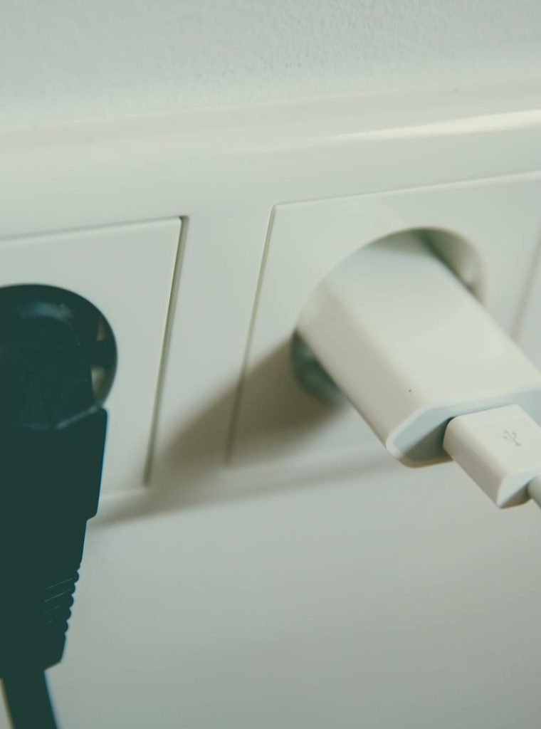 Photo by Markus Spiske Empresa Gómez Nucete Cabra A close-up view of a wall outlet with two plugs inserted, capturing the simplicity of electrical connectivity.